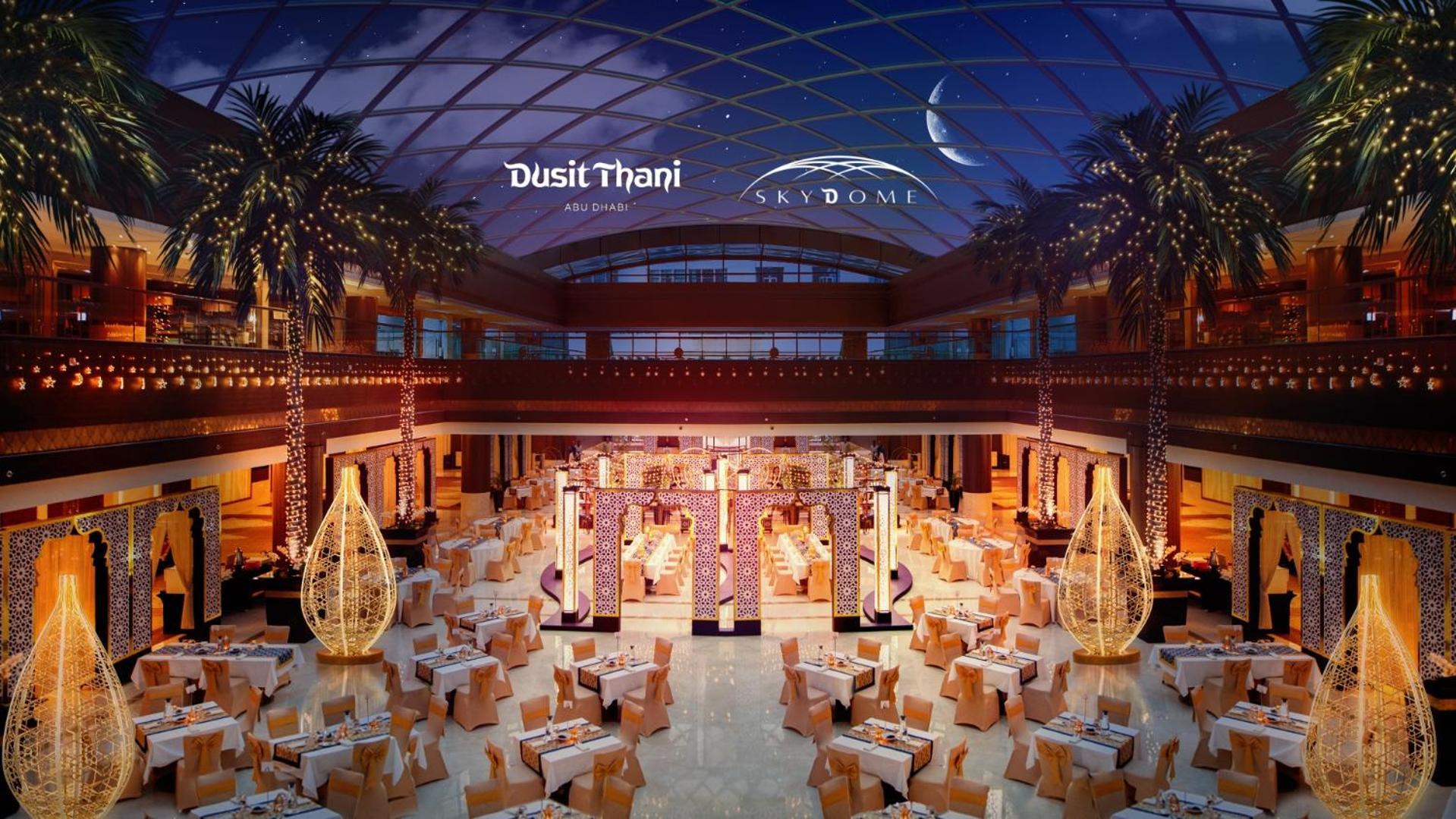 Dusit Thani Abu Dhabi Hotel Exterior photo The image depicts a luxurious dining space within a large venue, likely associated with Dusit Thani and Skydome. The interior features elegant decorations, including a spacious layout with numerous tables set for dining. Elegant lighting fixtures cre